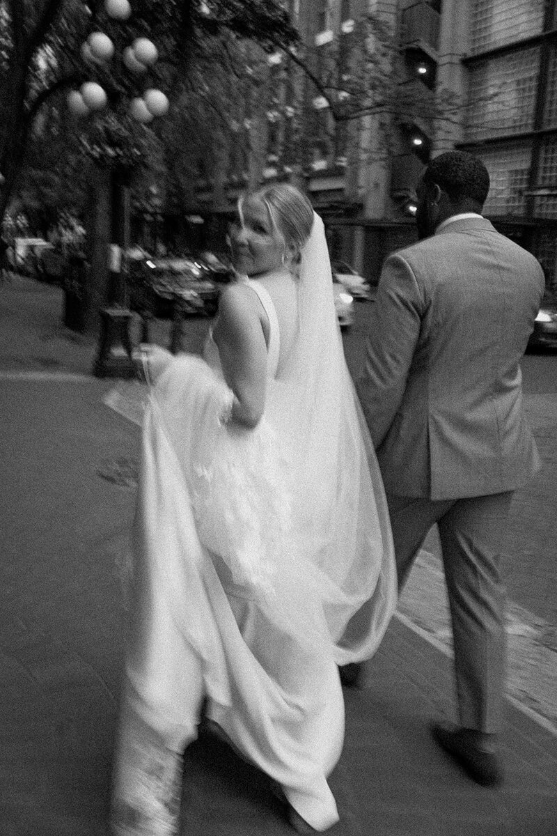 Vancouver wedding photographer captures couple walking down the street in Gastown Vancouver