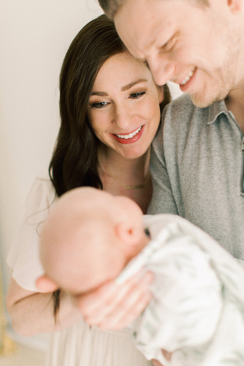 parents looking at newborn baby by nwi photographers