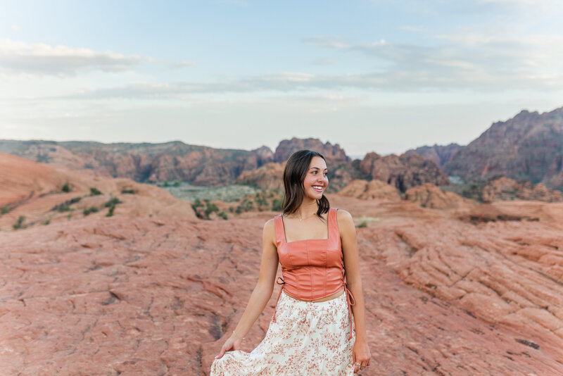 boy sitting on the hood of his truck and posing for senior photos in st george utah