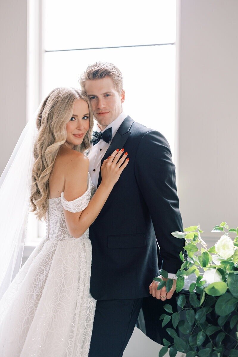 Joyful newlywed couple embracing just after their ceremony, captured in a romantic outdoor setting by a Milwaukee wedding photographer, Emily Barbara. 