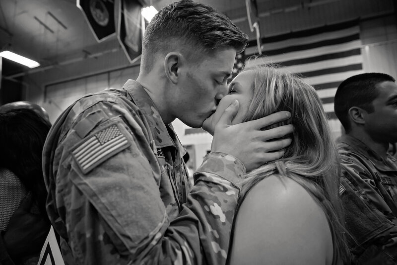 Military couple kissing after being reunited