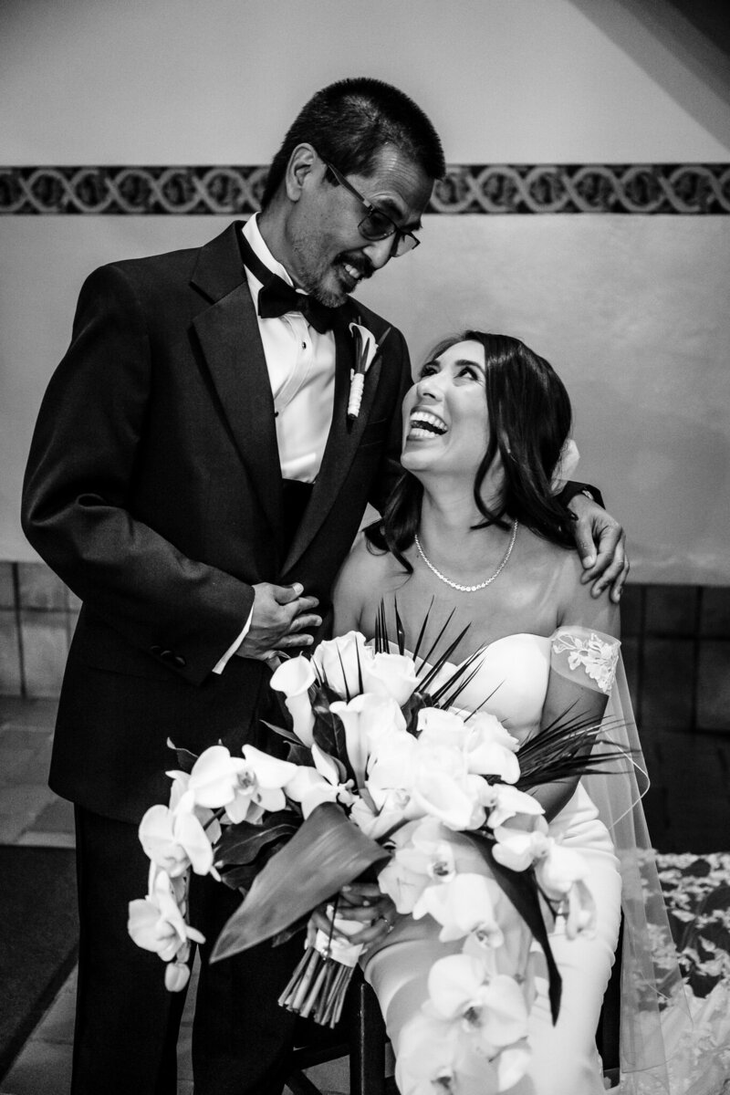 San Francisco Bay Area wedding photographer captures intimate black and white portrait of bride sharing tender moment with father holding bouquet