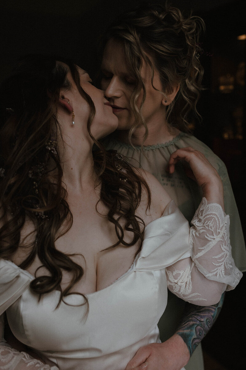 Intimate portrait of an LGBTQ+ couple sharing a quiet moment on their wedding day, photographed in a cinematic fine art style by Scottish wedding photographer Aly Robinson.