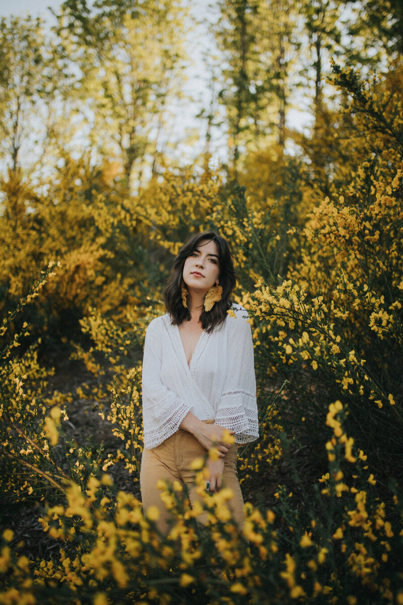 Girl in wildflower field senior portrait photographer