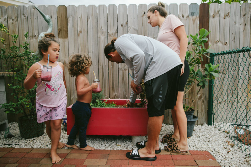 Family of Four gardening in their backyard