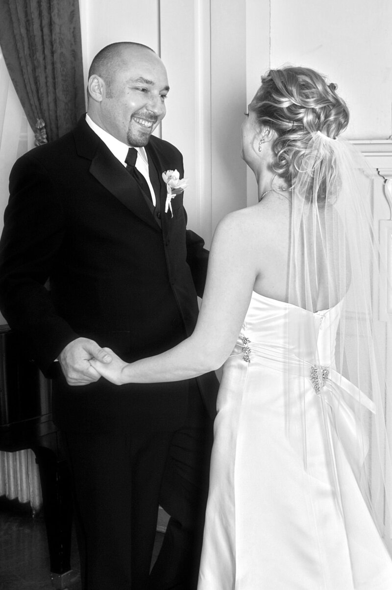 A Beth Sheridan bride kisses her groom after the wedding.