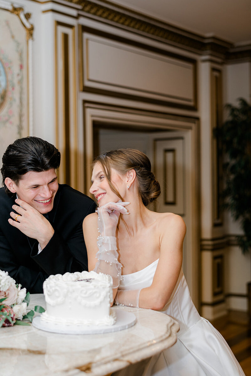 bride and groom with wedding cake