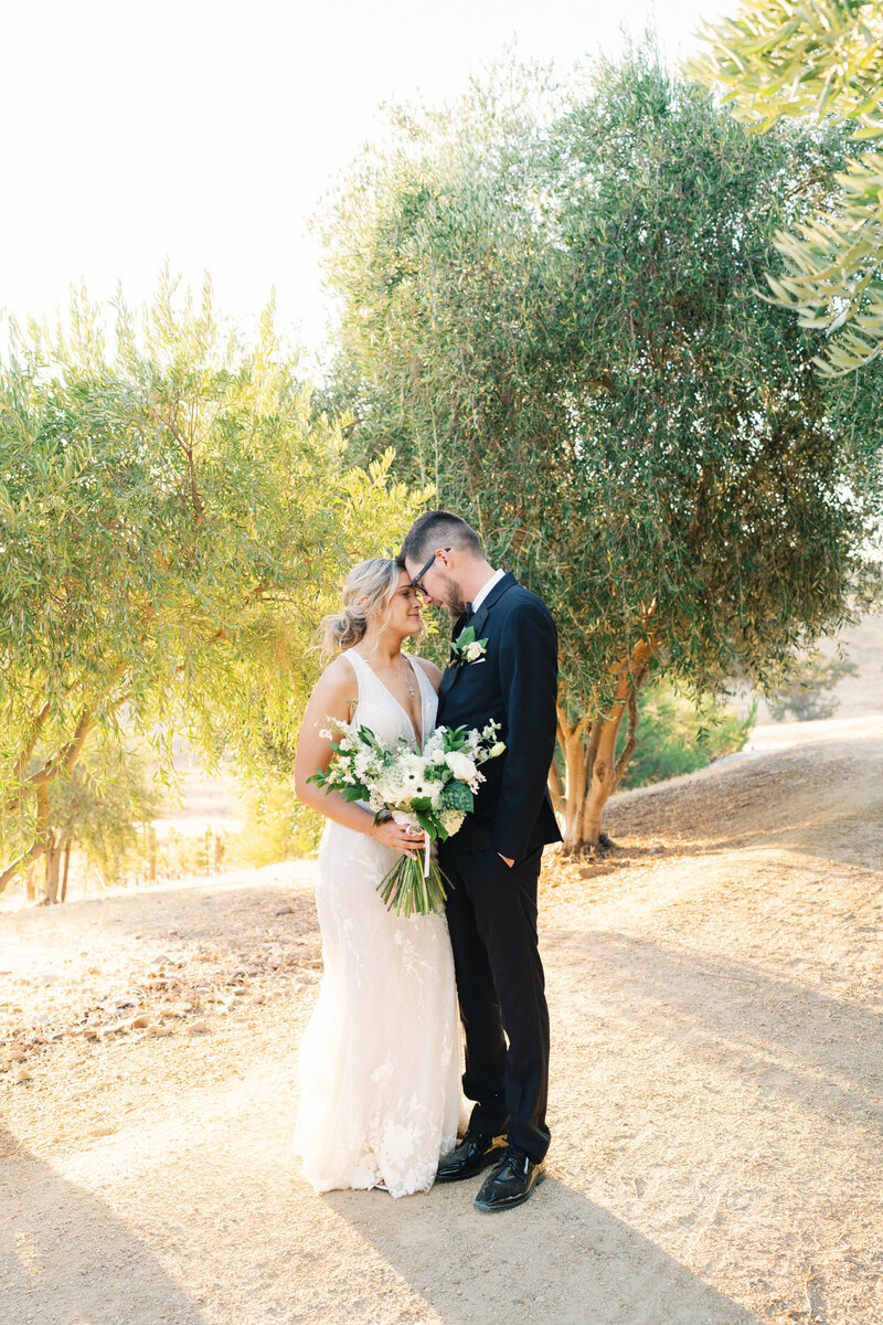 bride and groom take a moment to connect at sunset
