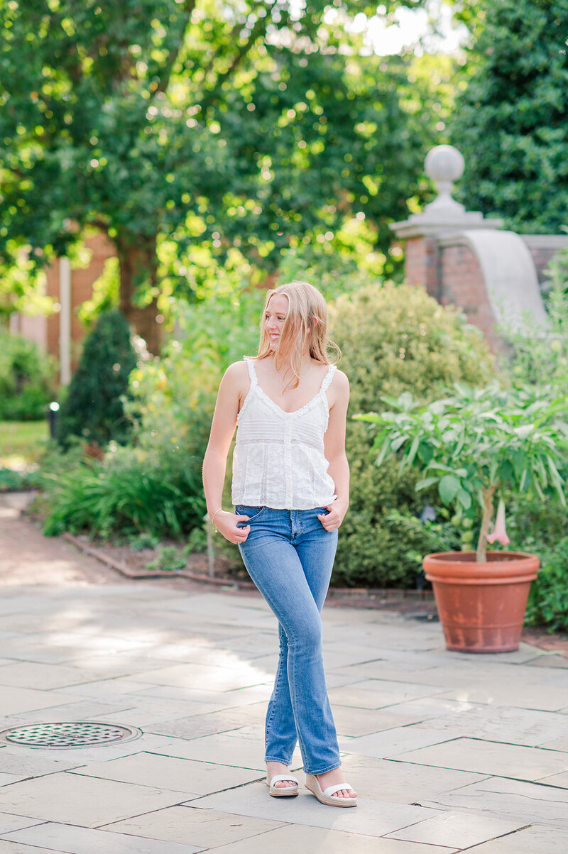 girl walking in jeans and a white blouse