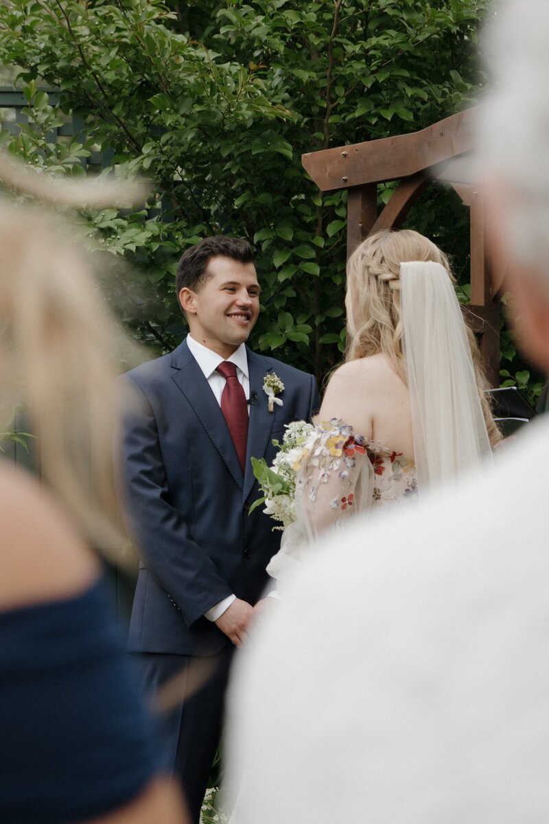 bride and groom standing at the alter