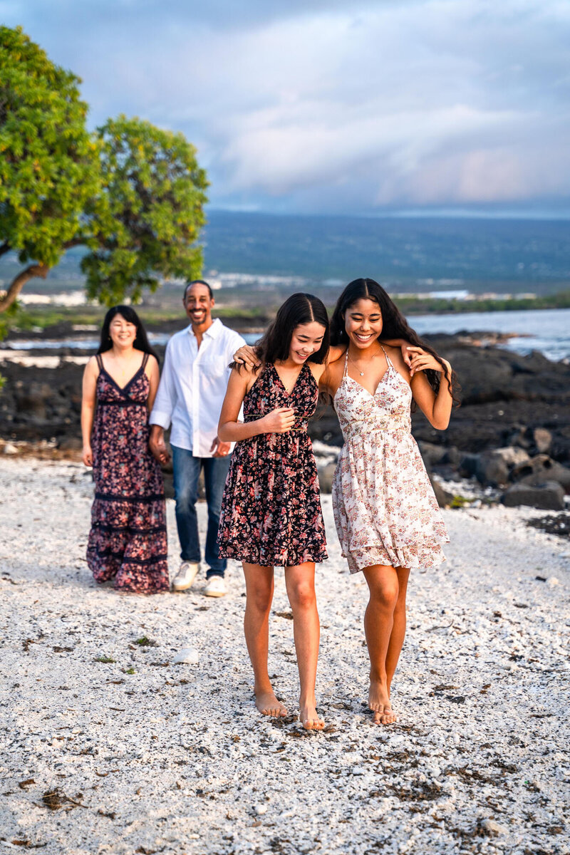 Family smiling on beach for portraits with Hawaii Adventure Portraits