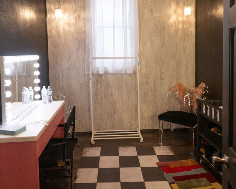 A look at a dressing room with vanity mirror and window