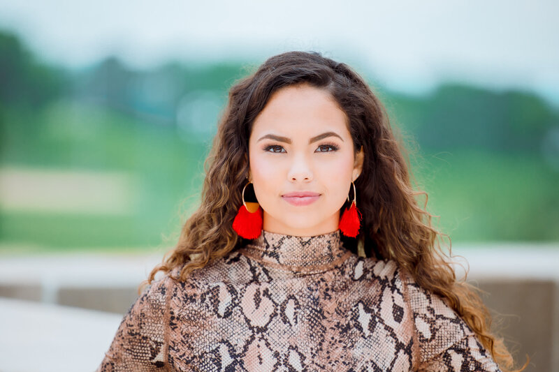 close up of senior girl in leopard print dress in a park in Kansas City MO