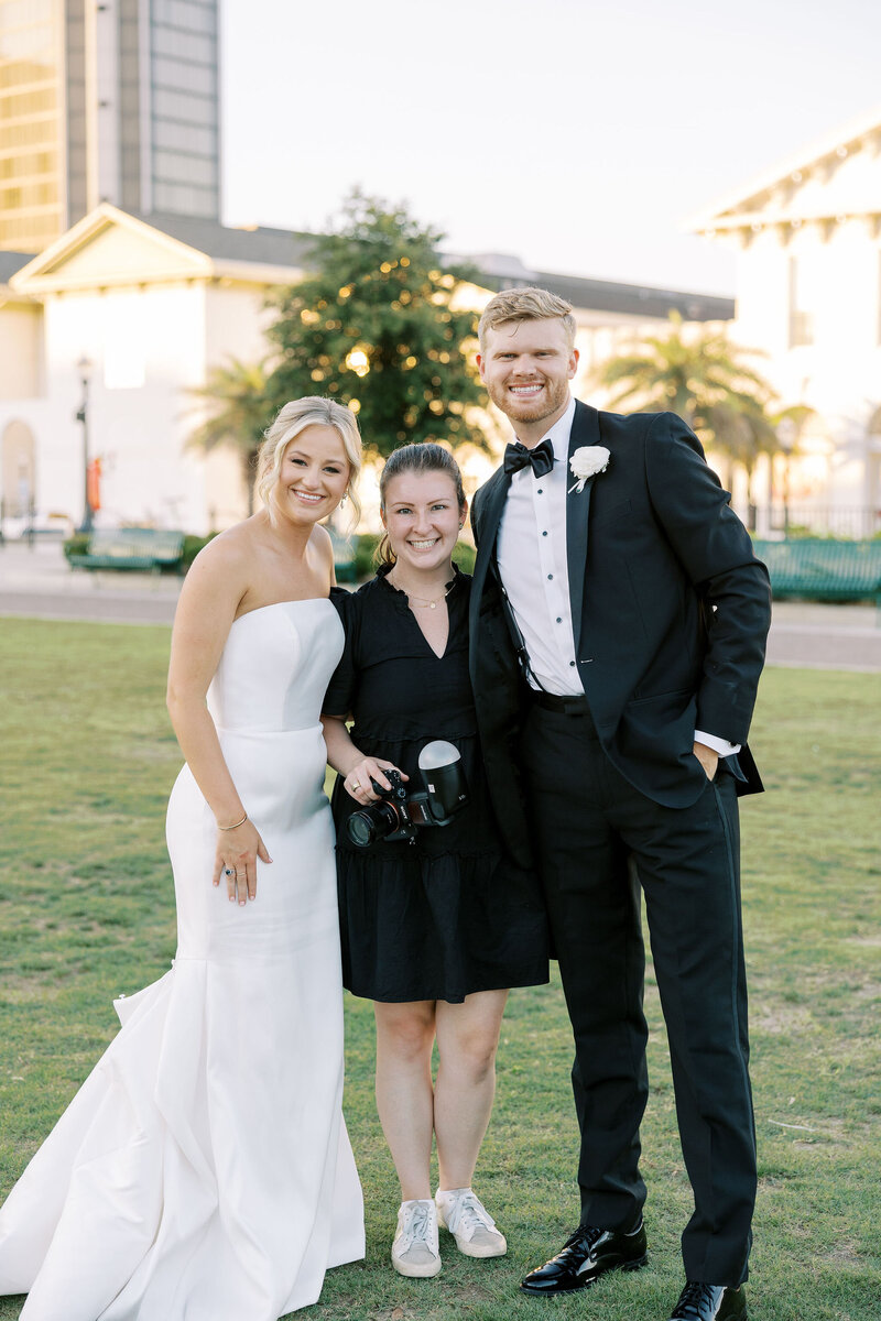 Emma standing with her clients on their wedding day
