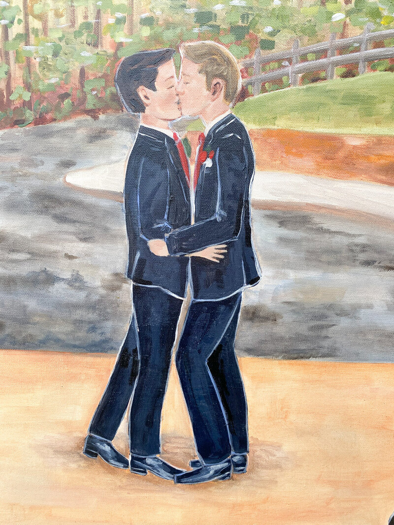 Close-up of a live wedding painting depicting a brunette groom and blond groom sharing a kiss