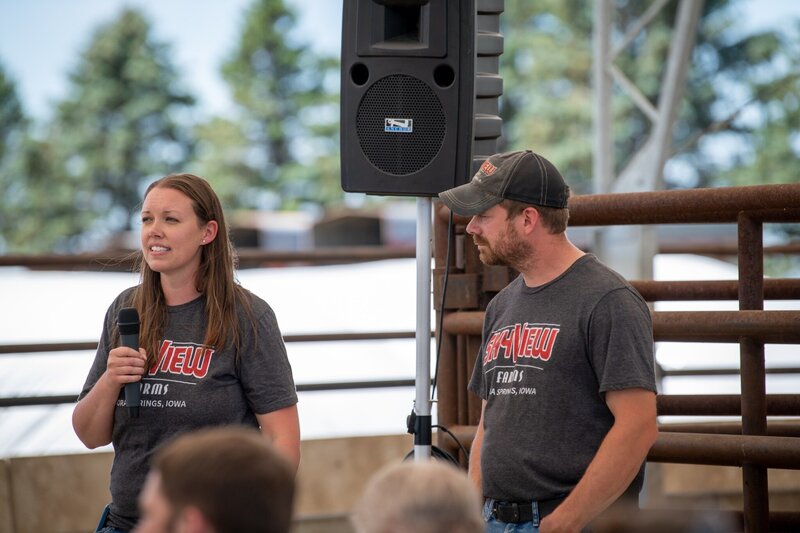 Husband and wife speaking at conference as cattle producers