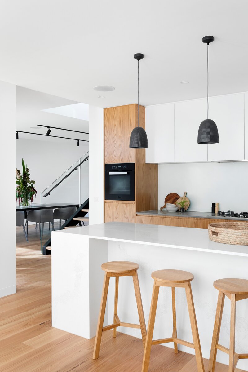 white, modern, clean kitchen design with light wood accents