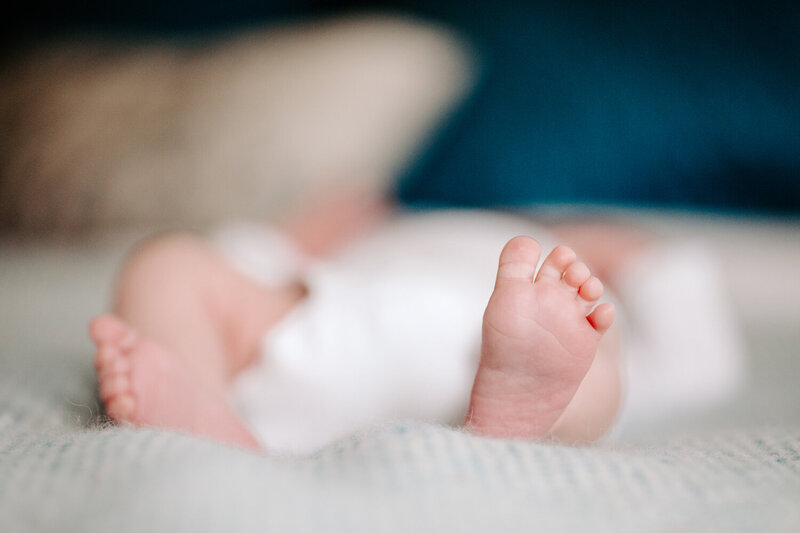 A close up photo of a newborn's tiny foot