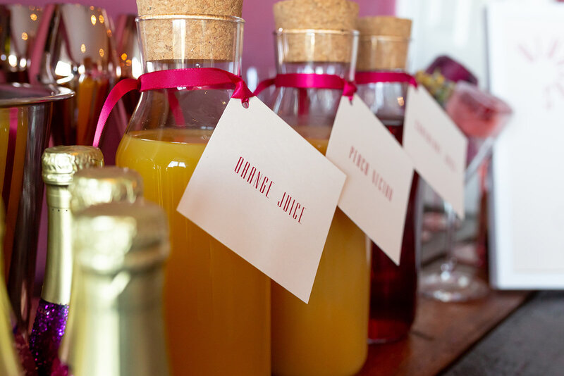Wedding mimosa bar signage on juice bottles