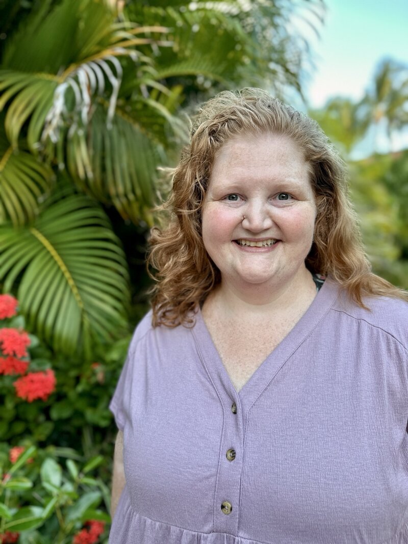 Dana, female founder of DWD travel, honeymoon, destination wedding & vacation planner walking on the beach
