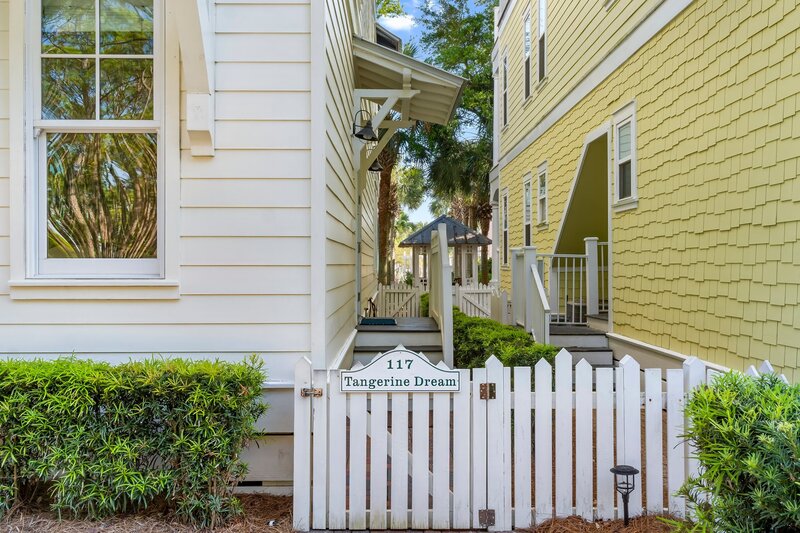 White picket gate labeled '117 Tangerine Dream' providing private access to the vacation property