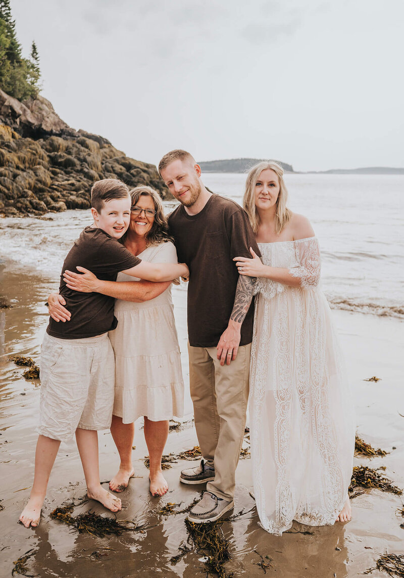 Family on the beach smiling together. Taken in New Brunswick.