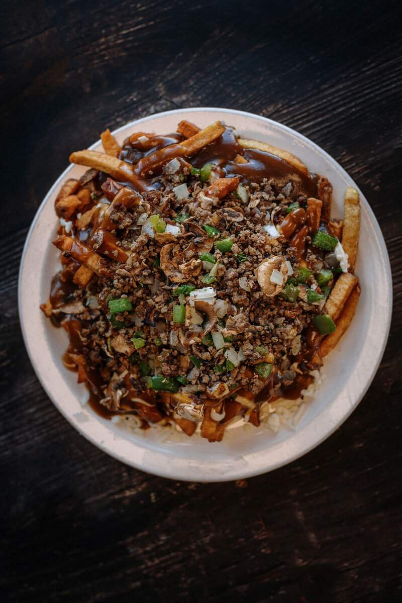 Fully loaded Redo’s poutine with ground beef, green peppers, onions, cheese curds, and gravy—customer favourite in Nova Scotia
