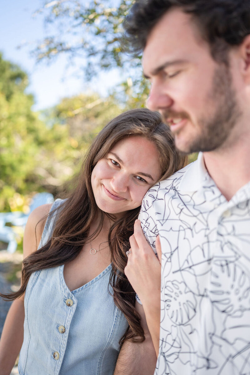 closeup of woman resting her head on man's shoulder