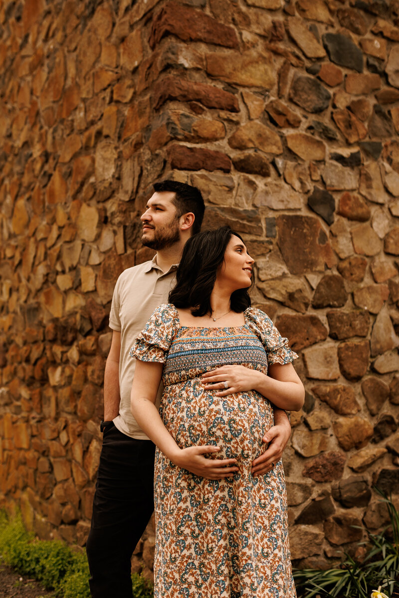 A man and woman in a maternity shoot