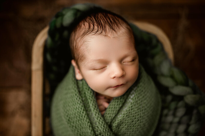 infant boy posed on blue picnic fabric backdrop
