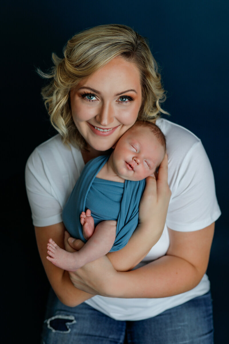 motherhood-new-mom-holding-baby-snuggling-baby-smiling