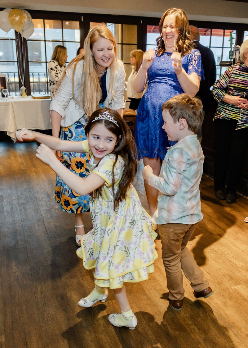 Candid photo of kids dancing at a fun party.