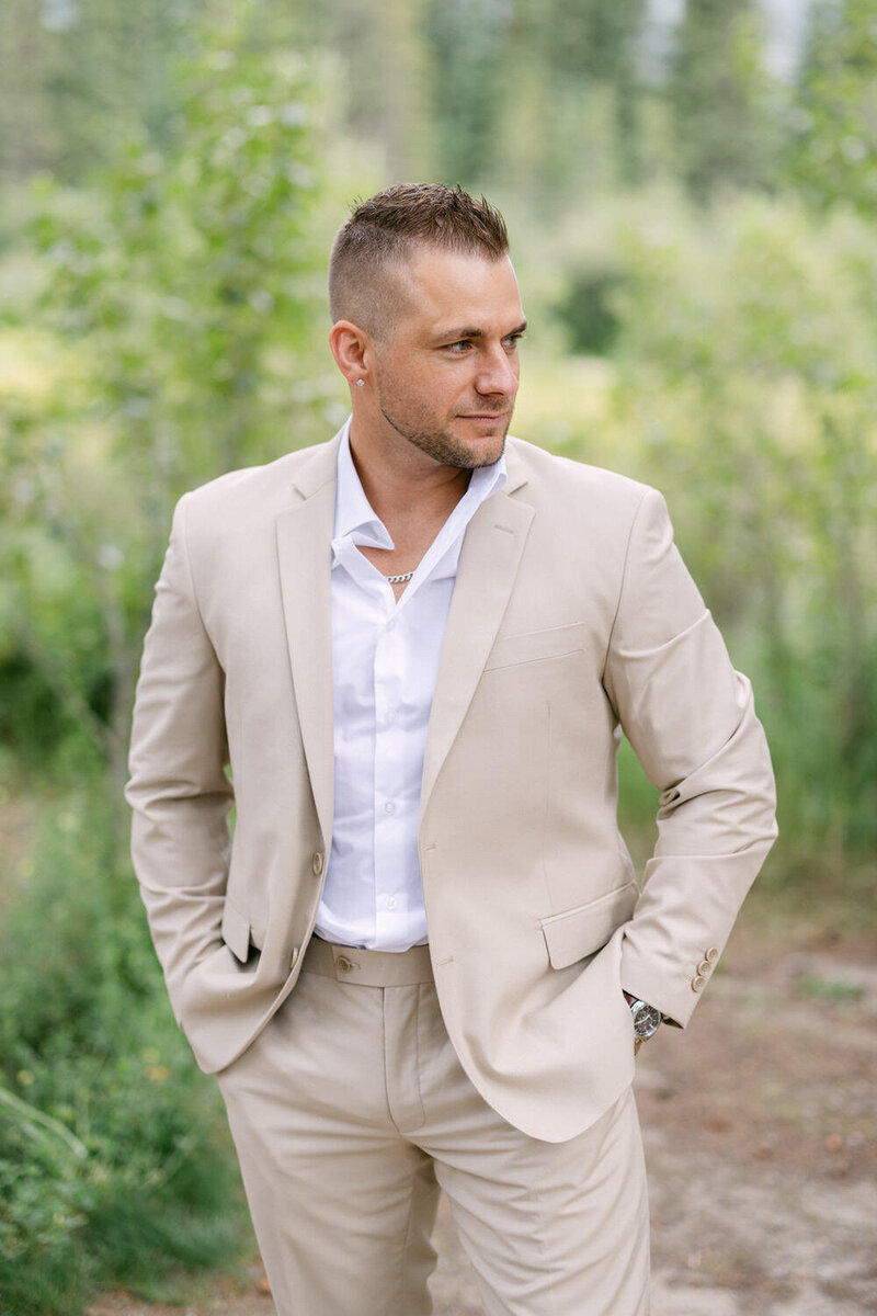 Groom preparing for his wedding day at the Malcolm Hotel in Canmore, surrounded by elegance and mountain views.