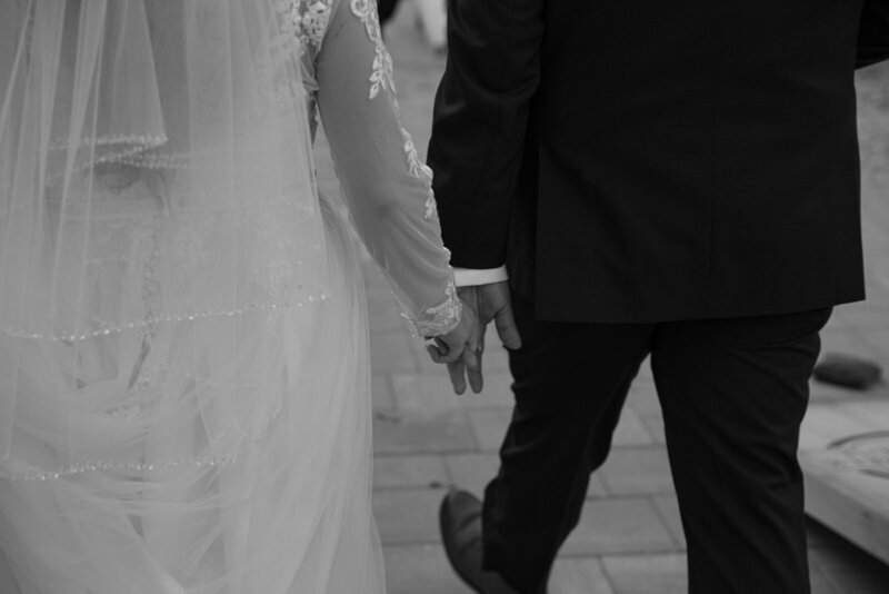 bride and groom holding hands walking together