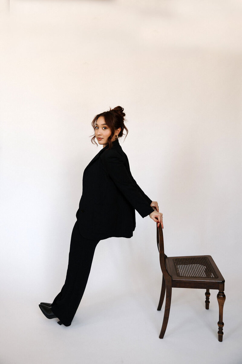 A person in a stylish trench coat holding a smart