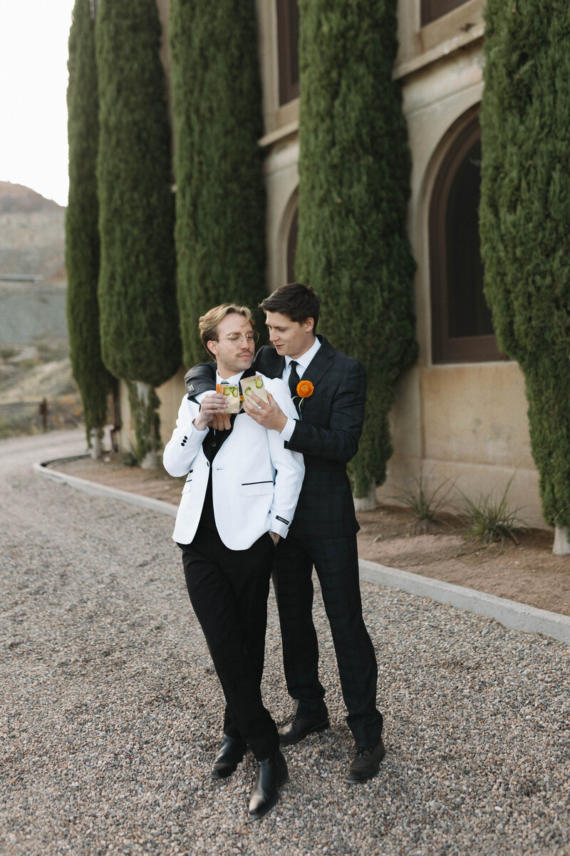 queer couple sharing a cocktail 