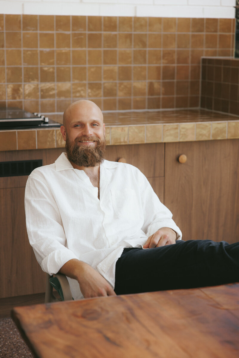 Jacob O'Neill sitting in the kitchen wearing a white shirt