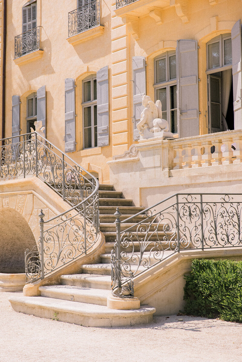 Ornate iron railing on white stone steps