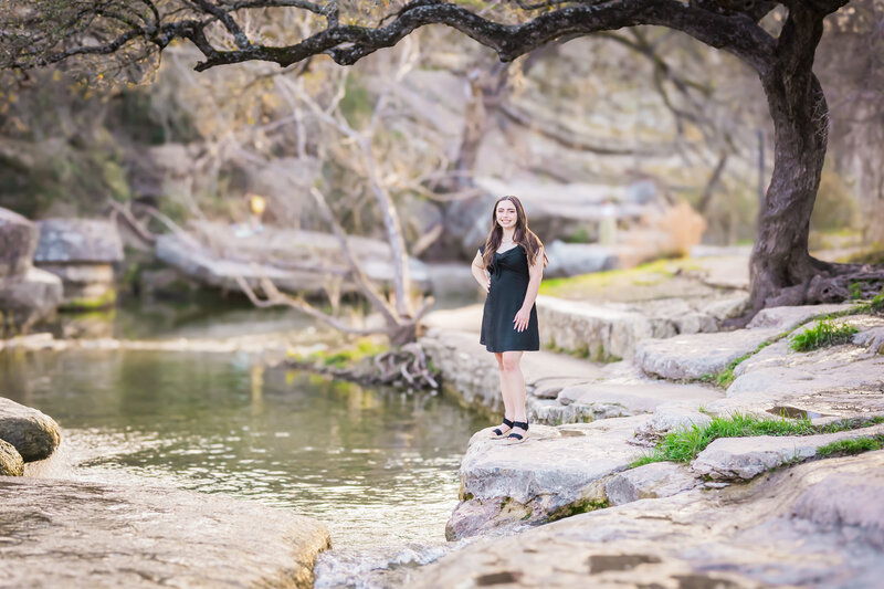 girl posing under a tree