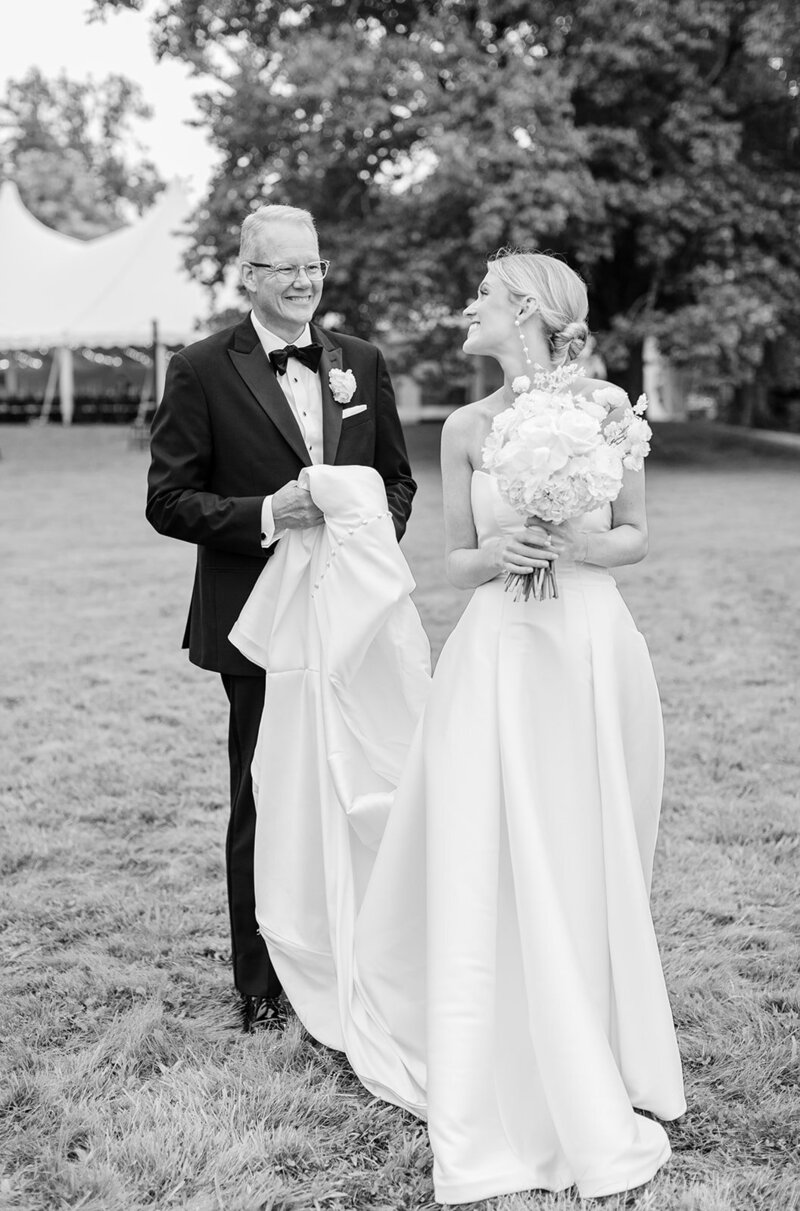 dad-holding-wedding-gown-ri