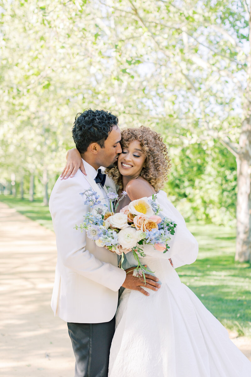 joyful-bride-groom-intimate-outdoor-wedding-portrait-floral-bouquet