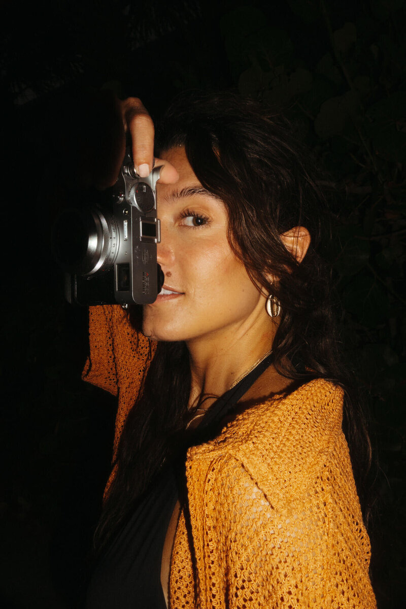 Girl taking photo with film camera