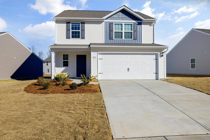 A two-story house with white and blue dutch lap vinyl siding installed by Perry Vinyl Windows & Doors in Hazard, Ky