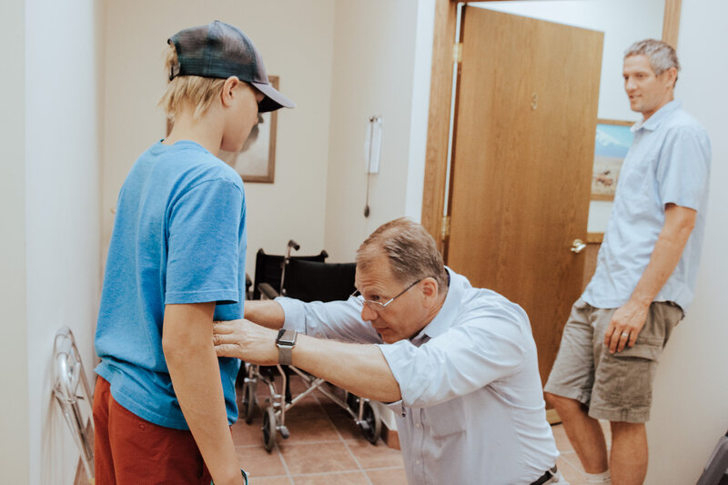 Tracy Duce, certified prosthetist and orthotist at Lethbridge Orthotics, examining a young child patient.