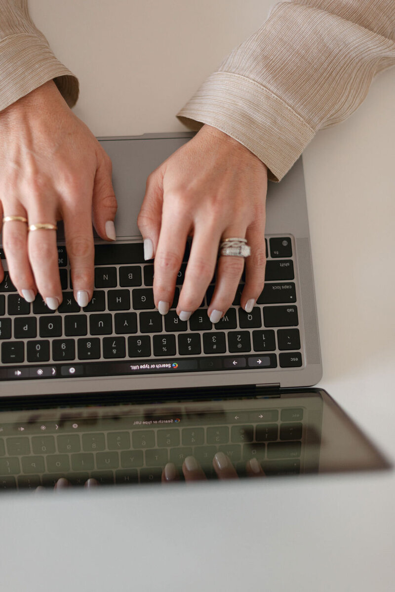 Woman typing on laptop