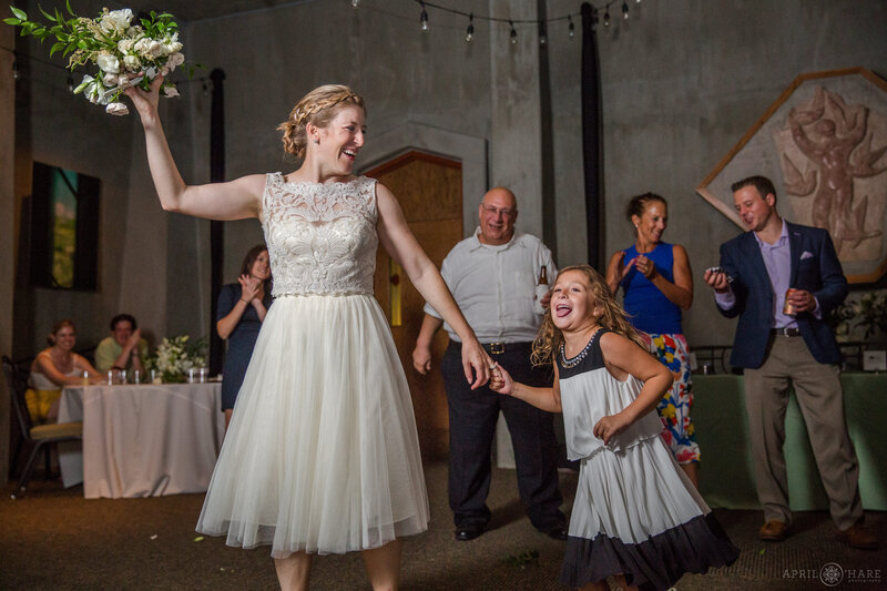 Tossing the bouquet at Gates Hall at Denver Botanic Gardens Wedding Reception