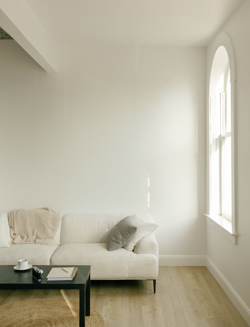 minimal, clean, natural light photography studio in Ohio with couch and coffee table, film branding photography