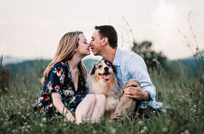 dog in between couple engaged nc