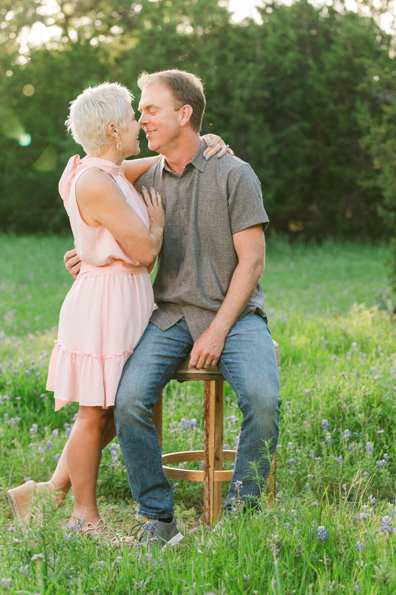 Spring Bluebonnet Portraits with a Mom and Dad during their family session . Photo taken by Dripping Springs Texas based Lydia Teague Photography.