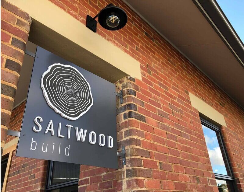 Saltwood Build sign outside on brick wall